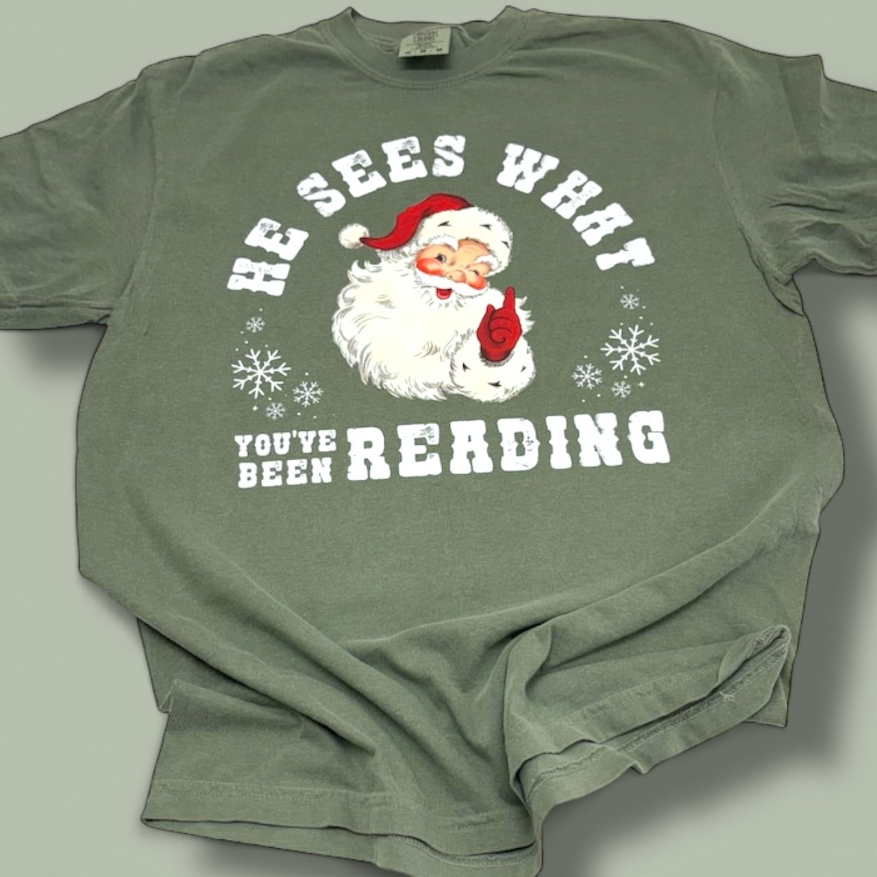 He Sees What You’ve Been Reading Santa T-Shirt